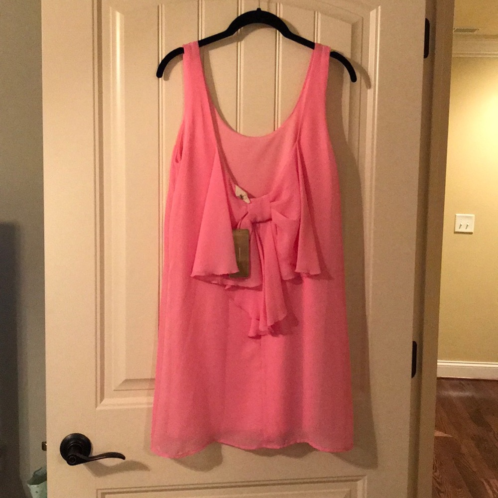 Pink sleeveless dress with low cut back with bow